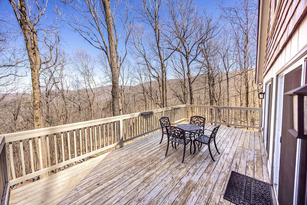1006 Chestnut Cove Trail Jasper, GA 30143 - Photo 28 of 33 a view of a table and chairs on the roof deck