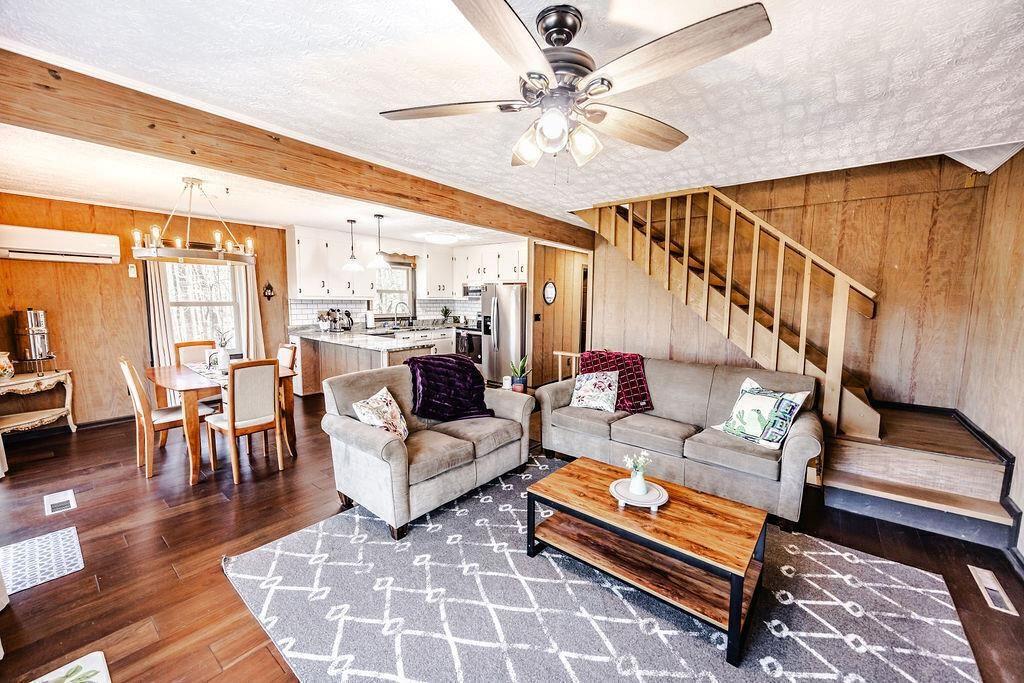 1006 Chestnut Cove Trail Jasper, GA 30143 - Photo 4 of 33 a living room with furniture a rug and a chandelier