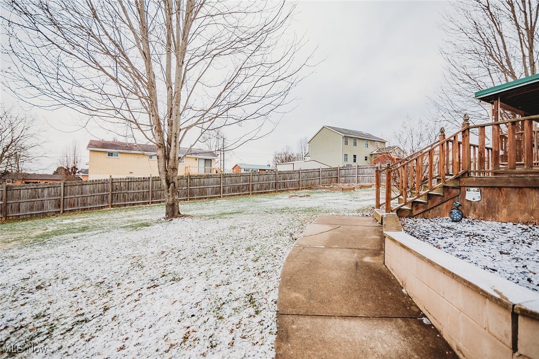91 Mike Street Washington, WV 26181 - Photo 34 of 42 Fenced backyard featuring stairs and a wooden deck