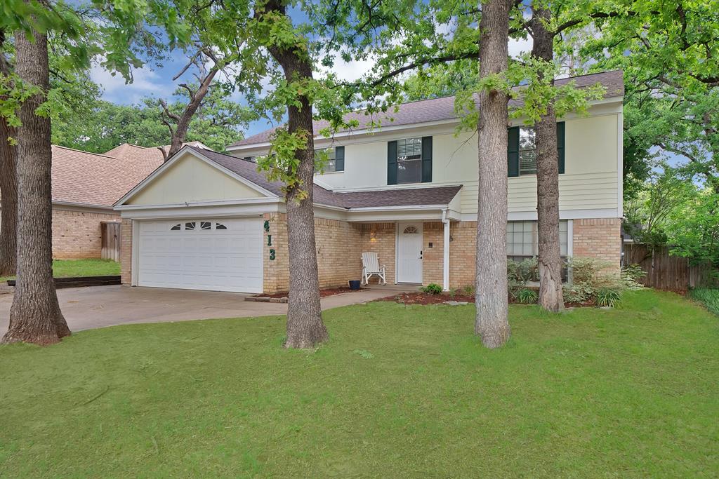 413 Wild Oak Lane Euless, TX 76039 - Photo 1 of 1 a front view of a house with a garden and yard