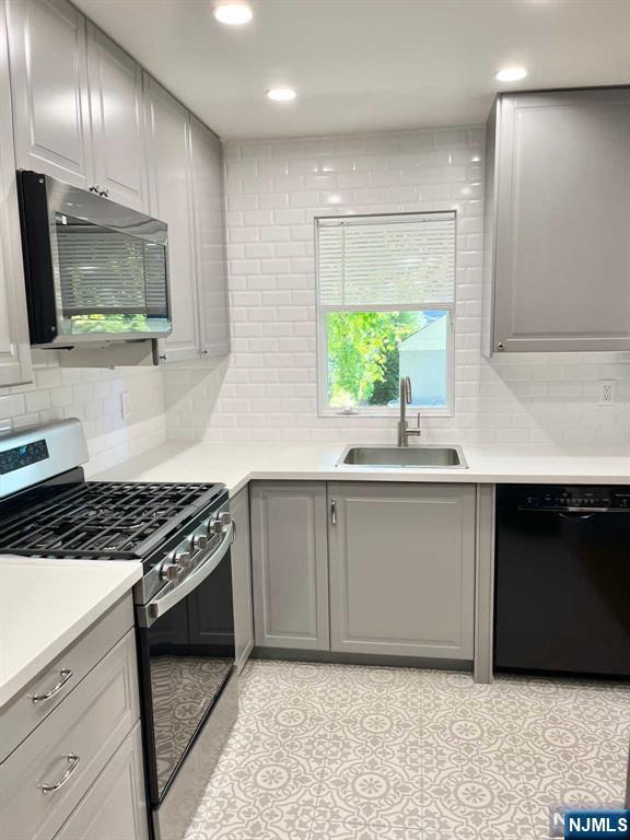 678 Grove Street Ridgewood, NJ 07450 - Photo 3 of 14 a kitchen with granite countertop a sink stainless steel appliances and cabinets