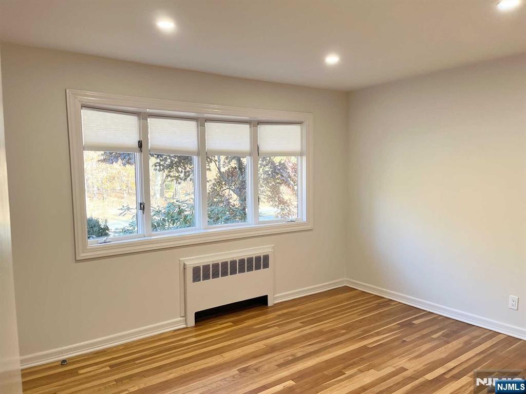 678 Grove Street Ridgewood, NJ 07450 - Photo 4 of 14 a view of an empty room with wooden floor and a window