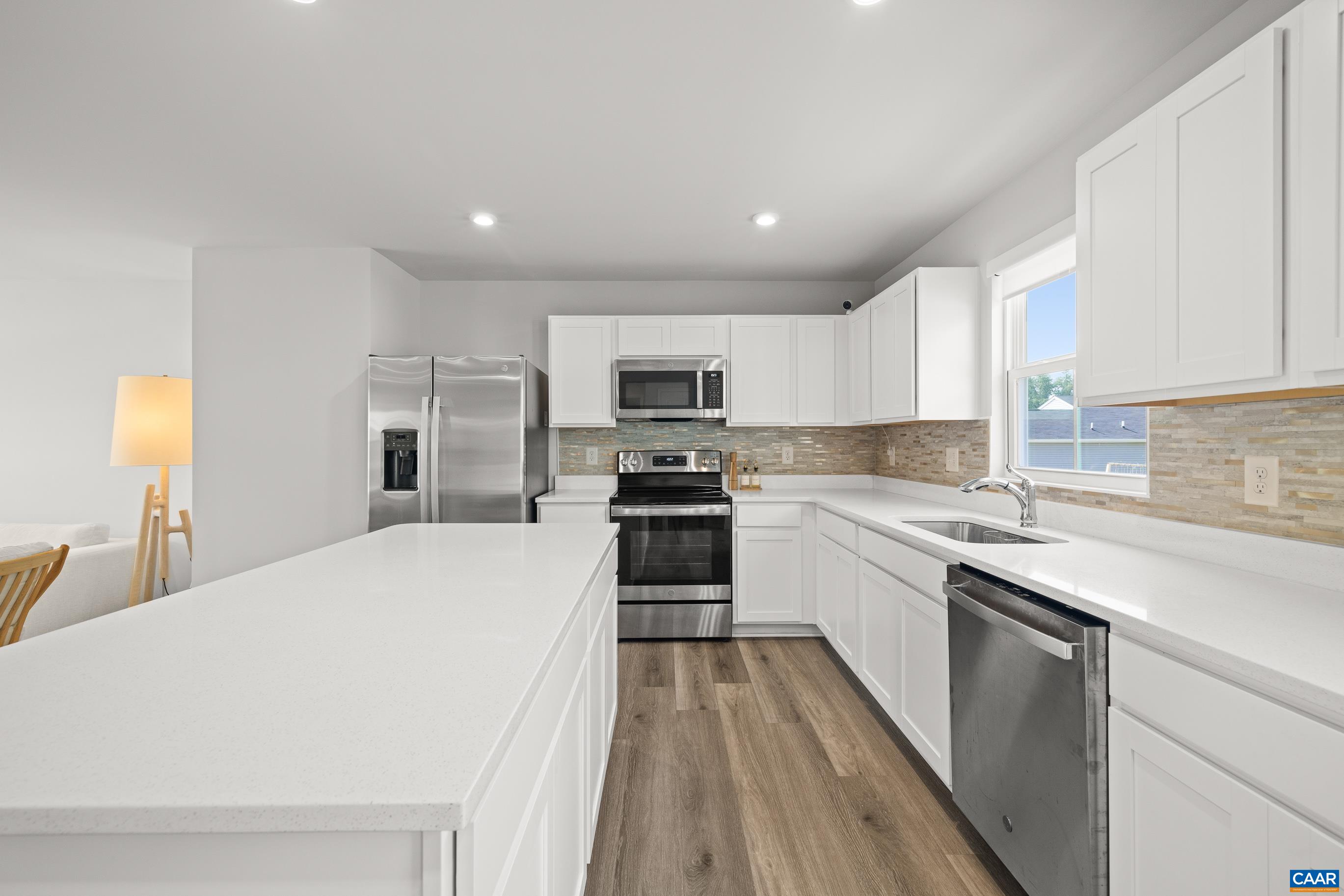 132 White Birch Road Waynesboro, VA 22980 - Photo 11 of 47 a white kitchen with wooden floor and stainless steel appliances