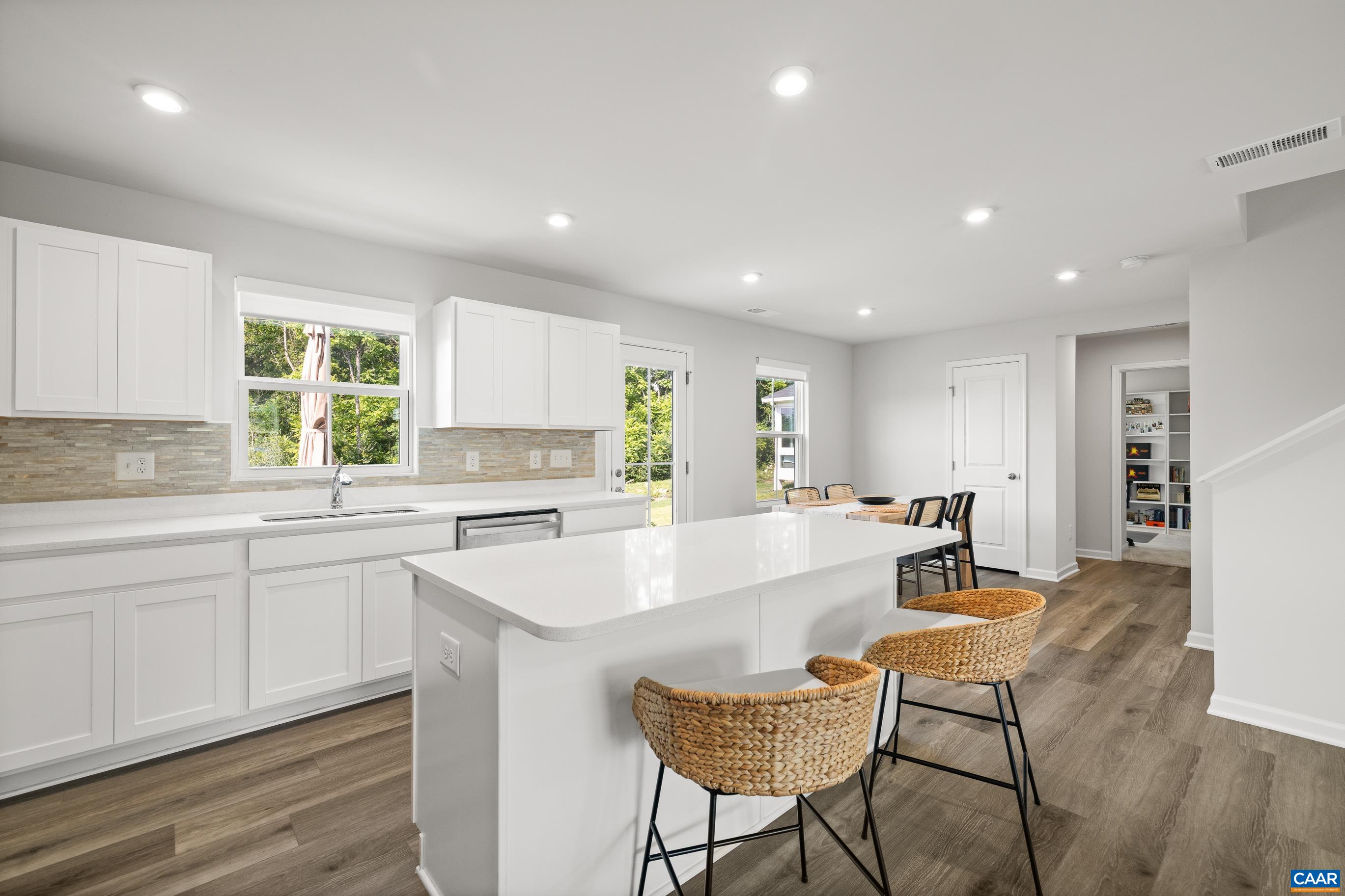 132 White Birch Road Waynesboro, VA 22980 - Photo 12 of 47 a large white kitchen with kitchen island a table and chairs in it