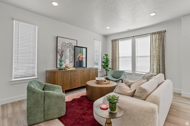 3074 South 270 West Logan, UT 84321 - Photo 5 of 30 Recessed lighting illuminates this bright space featuring multiple windows with blinds, wood-finish flooring, and a built-in media console