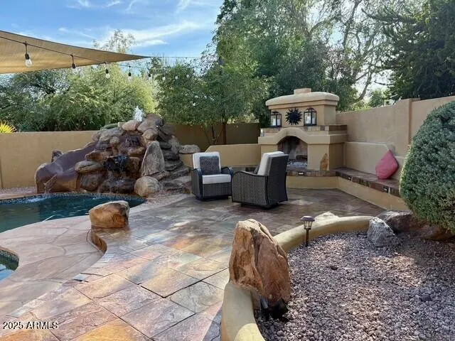 a roof deck with couches and potted plants