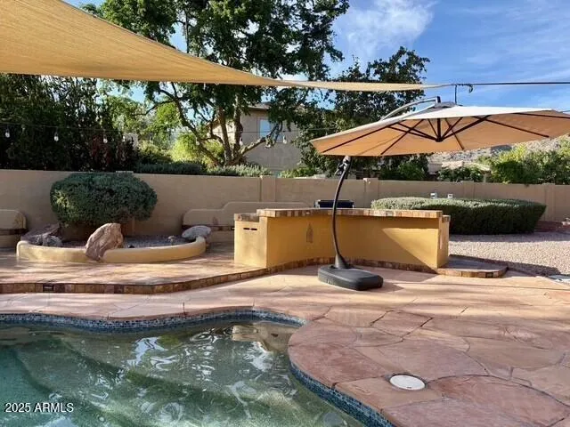 a view of swimming pool with seating space