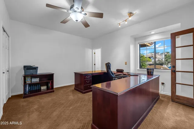 a bathroom with a granite countertop toilet sink and mirror