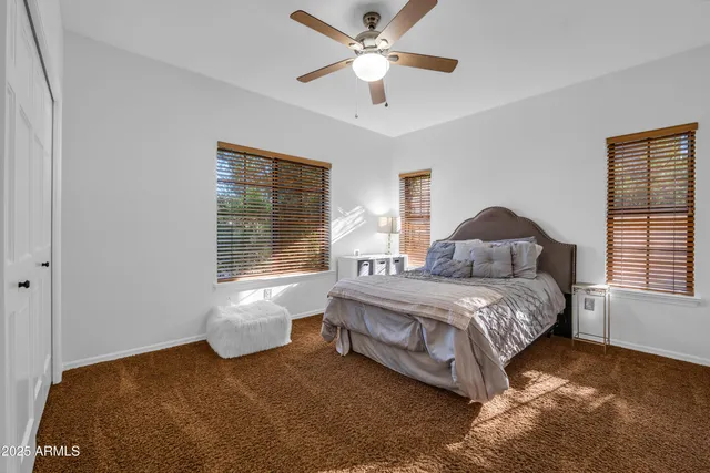 a bathroom with a granite countertop double vanity sink and a large mirror
