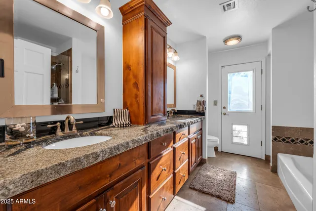 a kitchen with stainless steel appliances granite countertop a sink stove and cabinets