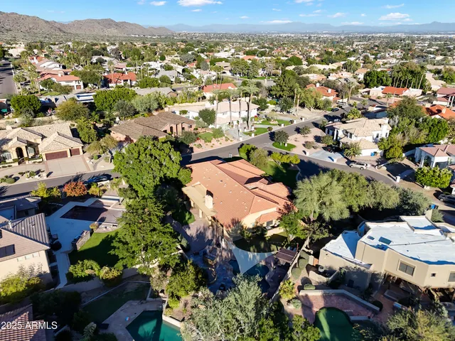 an aerial view of a house with a yard and garden
