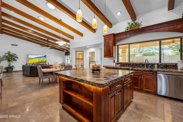 a kitchen with stainless steel appliances granite countertop a sink stove and cabinets