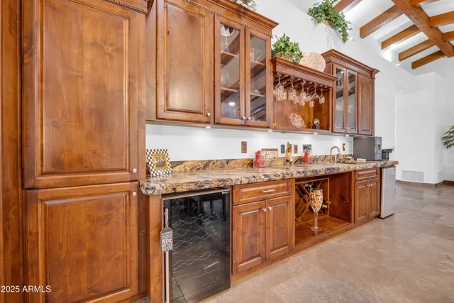 a kitchen with stainless steel appliances granite countertop a sink and a refrigerator