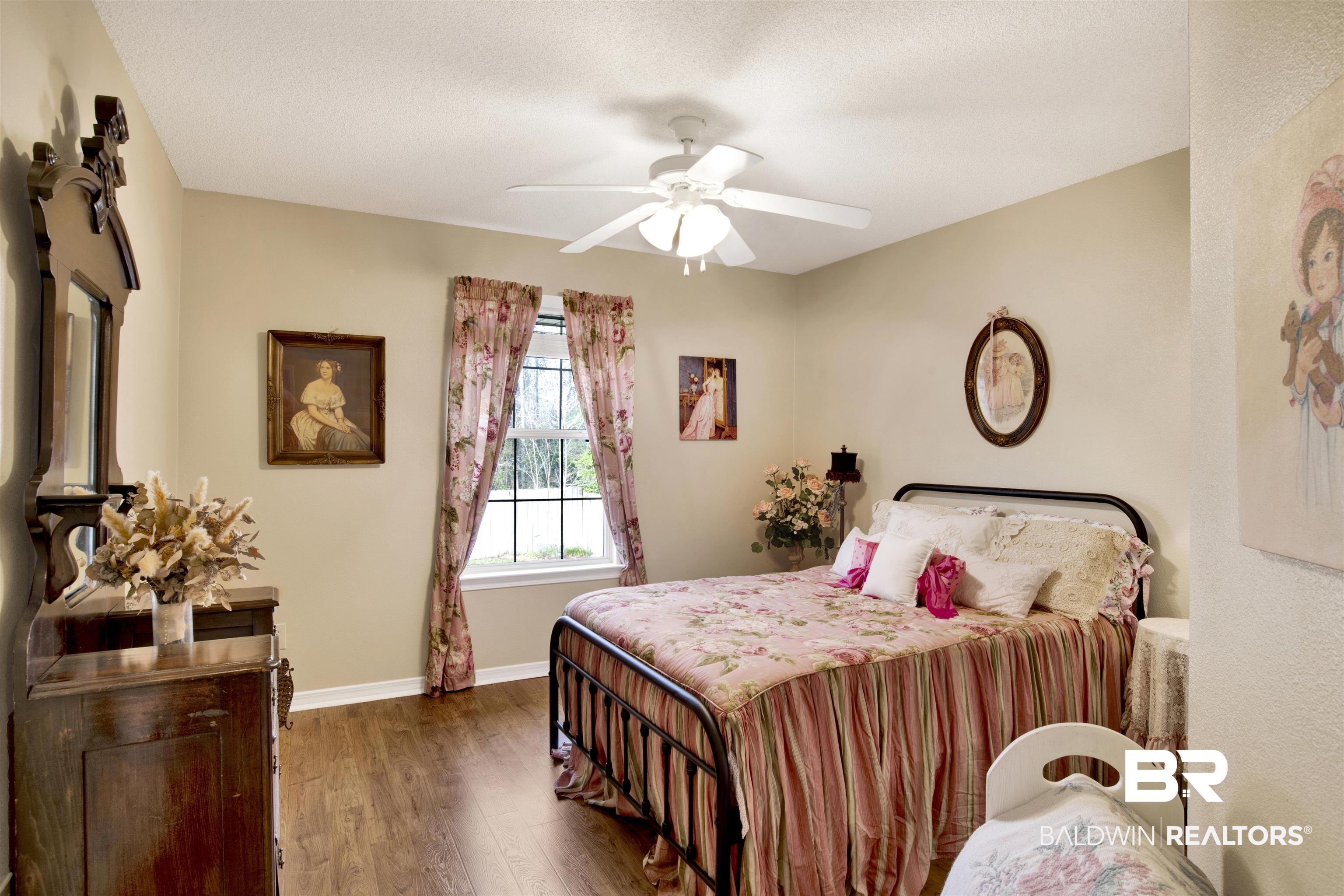 11697 Balsam Court Daphne, AL 36527 - Photo 22 of 31 Bedroom with dark wood-type flooring, a textured ceiling, and ceiling fan