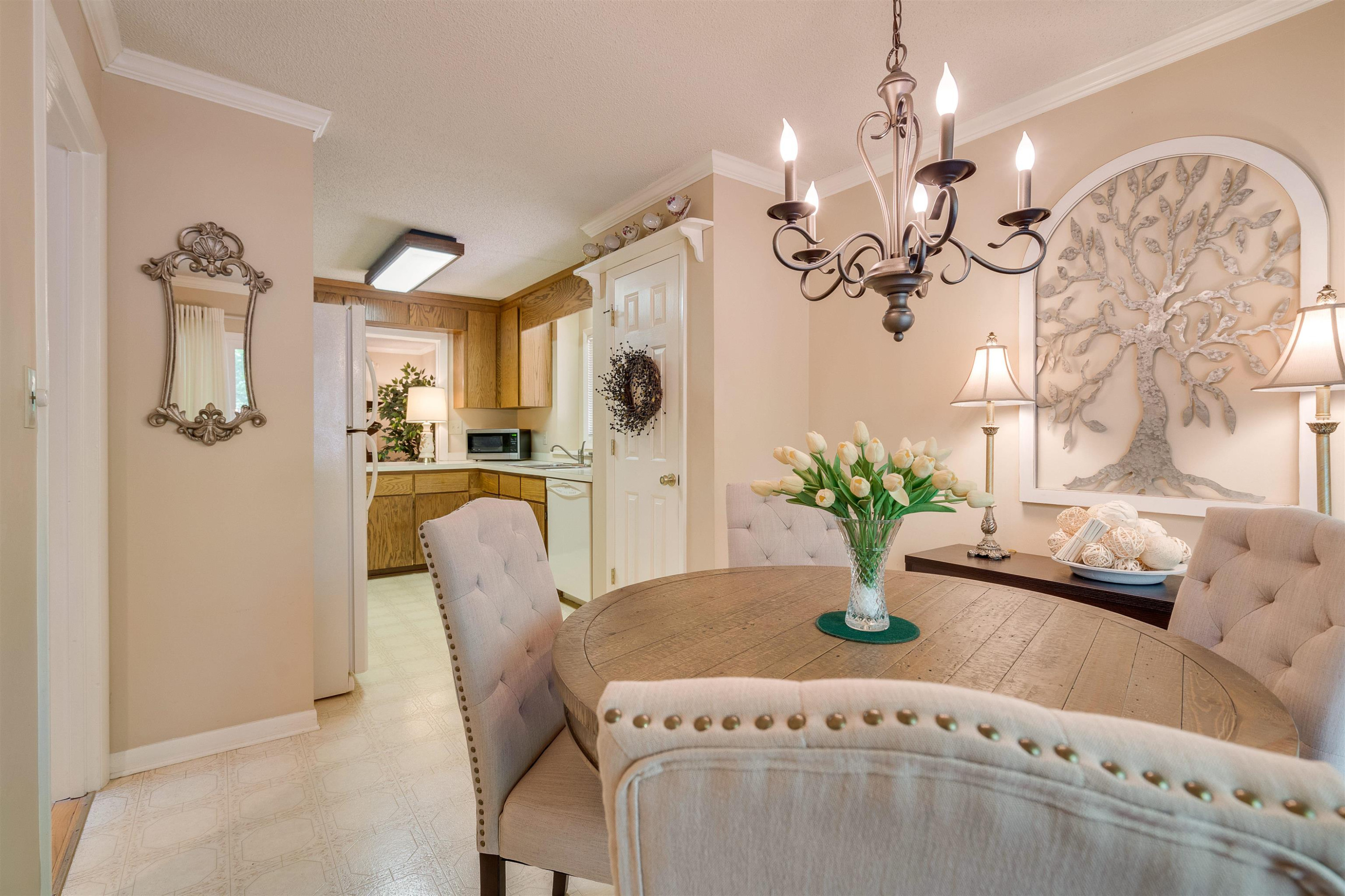1 Pinnacle Road Durham, NC 27705 - Photo 14 of 38 a dining room with furniture a chandelier and wooden floor