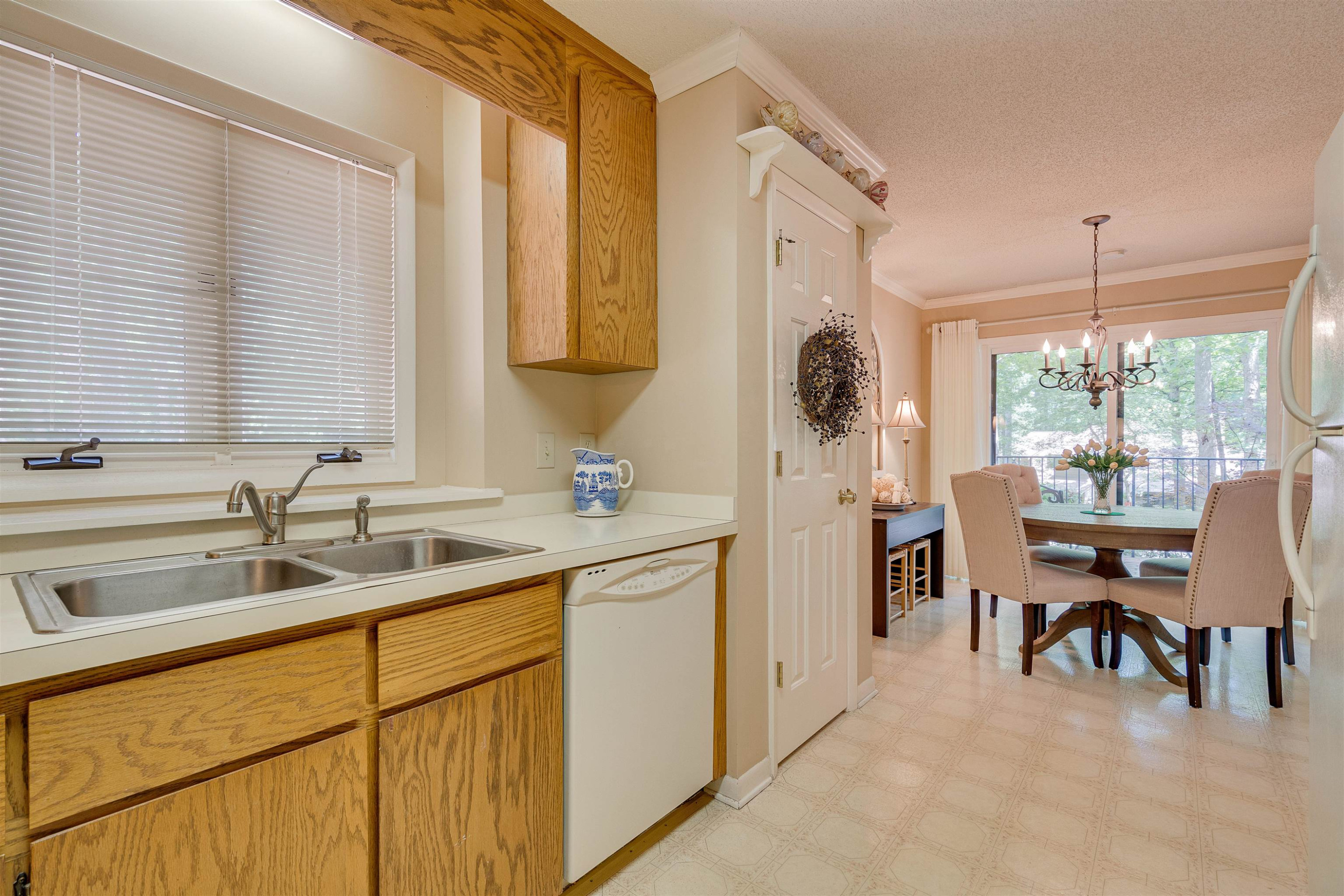 1 Pinnacle Road Durham, NC 27705 - Photo 18 of 38 a kitchen with a sink cabinets and dining table chair