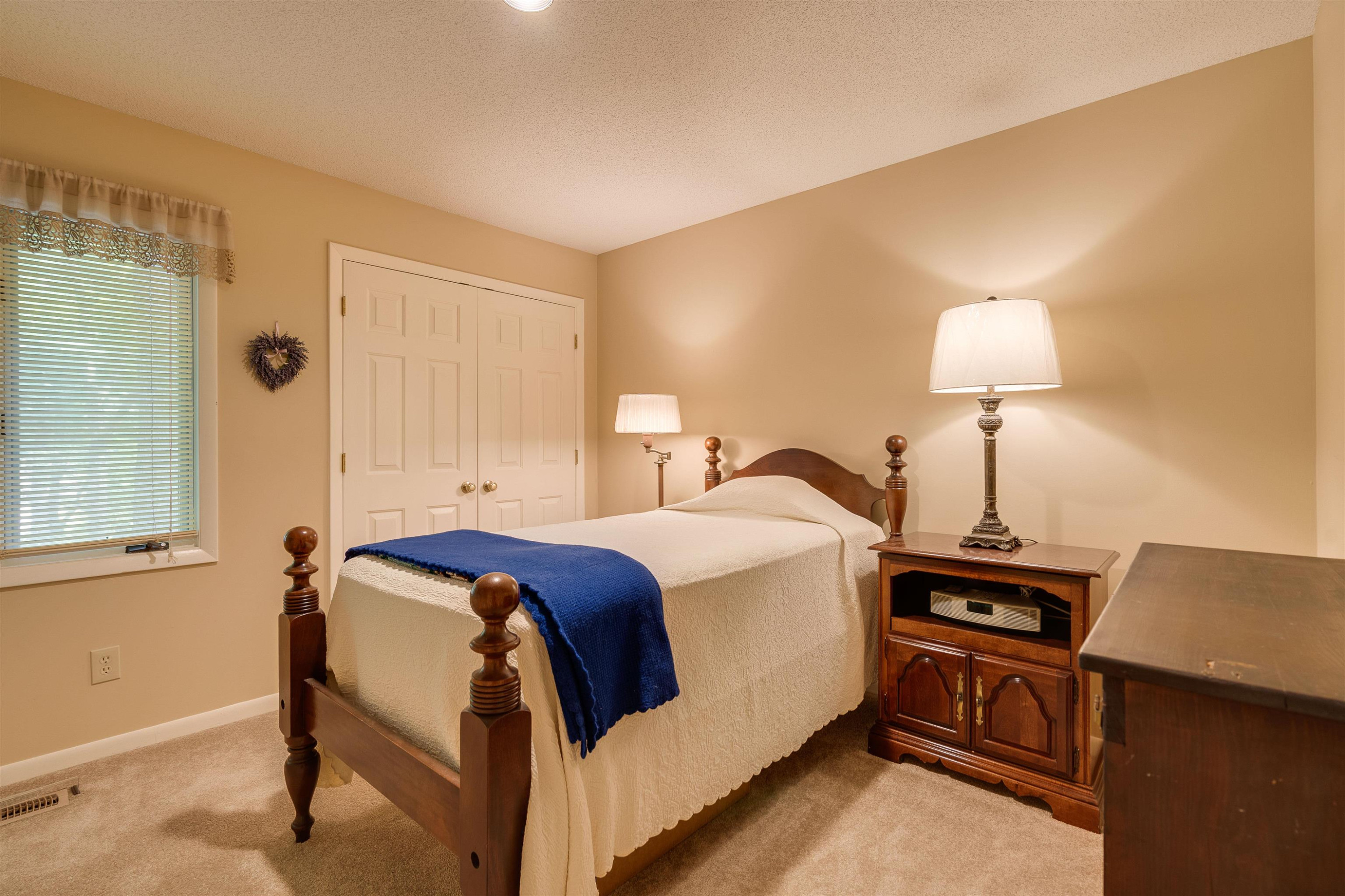 1 Pinnacle Road Durham, NC 27705 - Photo 26 of 38 a bedroom with a bed and a lamp on table