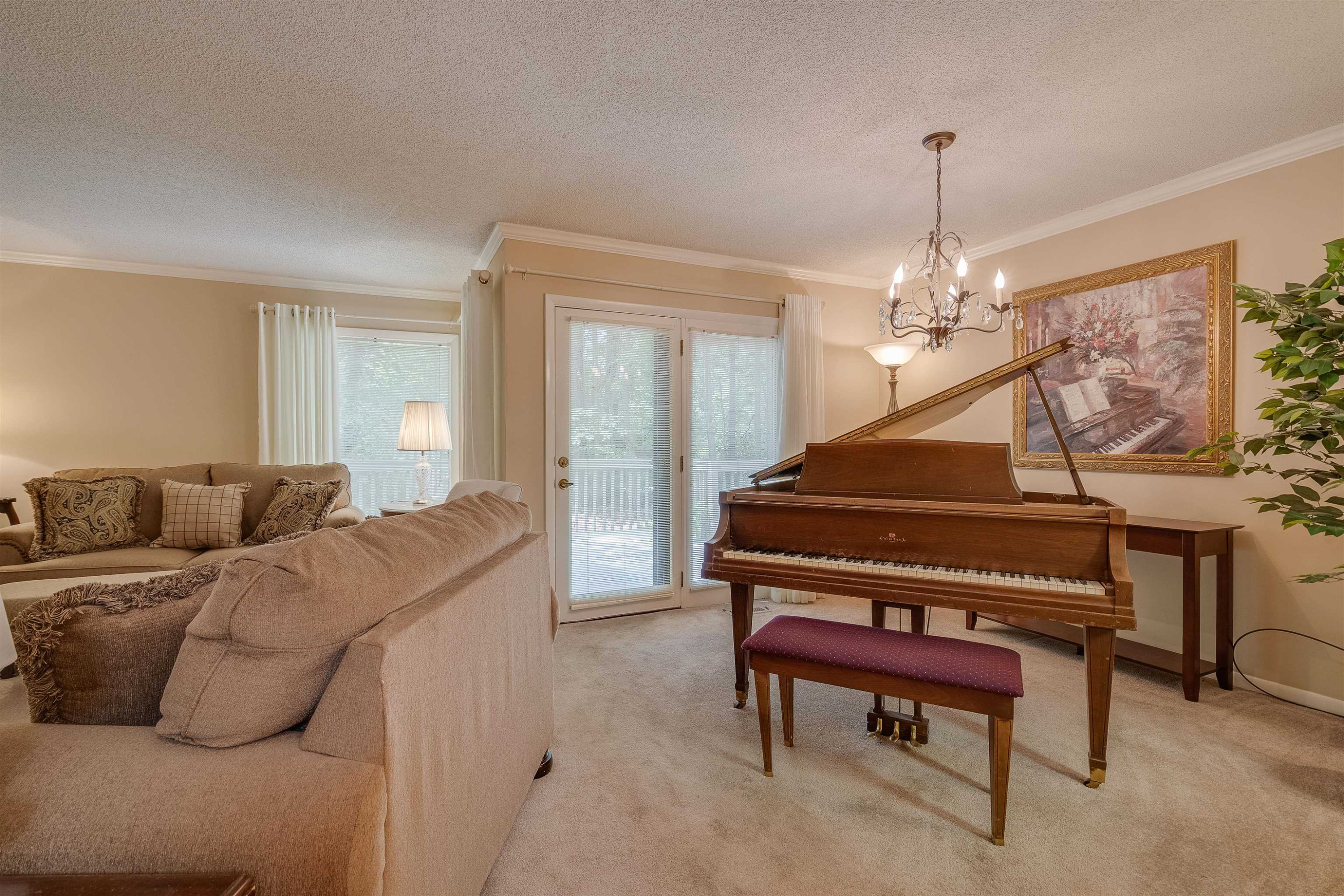 1 Pinnacle Road Durham, NC 27705 - Photo 10 of 38 a living room with furniture and a chandelier