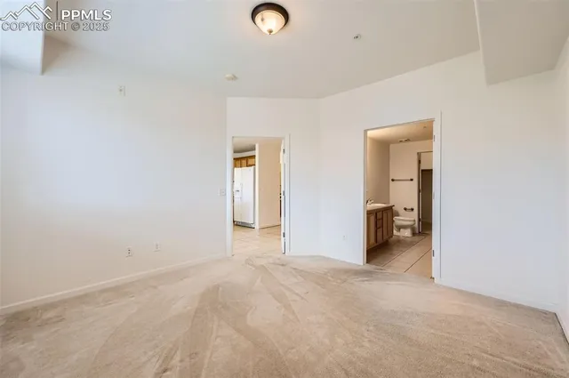 an empty room with a bathroom and a sink