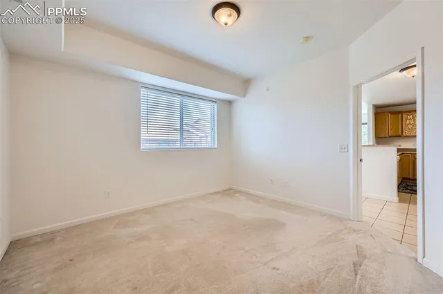 an empty room with closet and a window