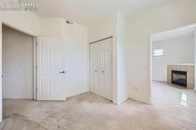 a view of an empty room with a fireplace