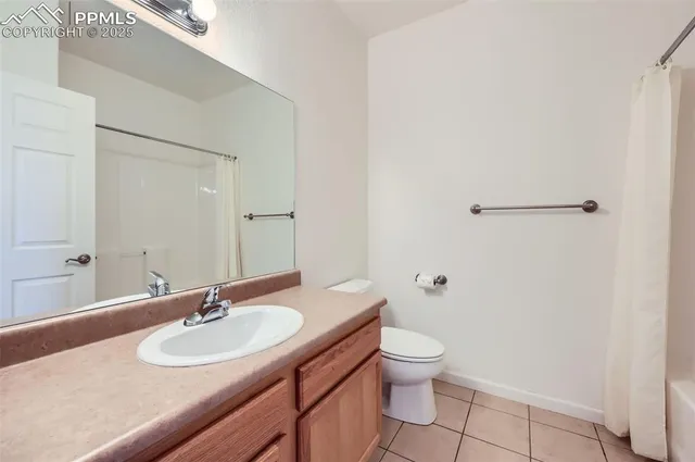 a bathroom with a sink toilet and a mirror