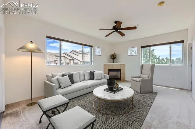 a living room with furniture and a fireplace