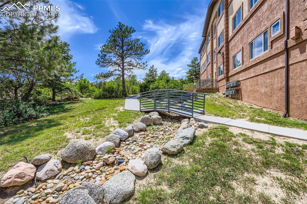 3755 Hartsock Lane, Unit 203 Colorado Springs, CO 80917 - Photo 34 of 43 a view of a yard with plants and wooden fence
