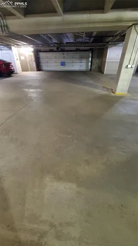 a view of parking garage with cars