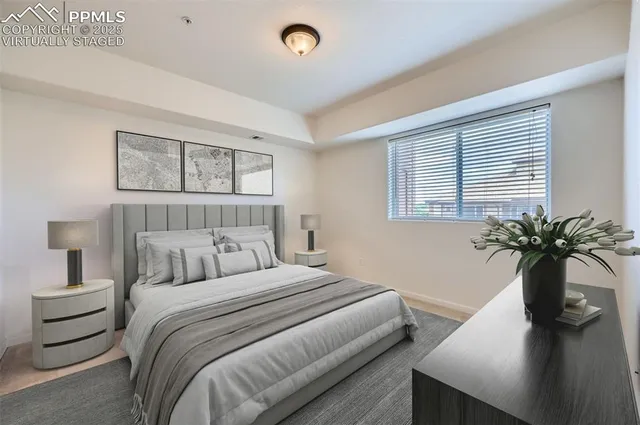 a bedroom with a large bed and a potted plant