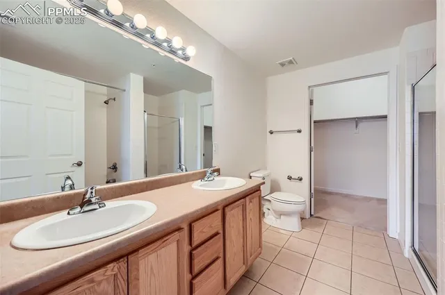 a bathroom with a sink double vanity granite and a mirror