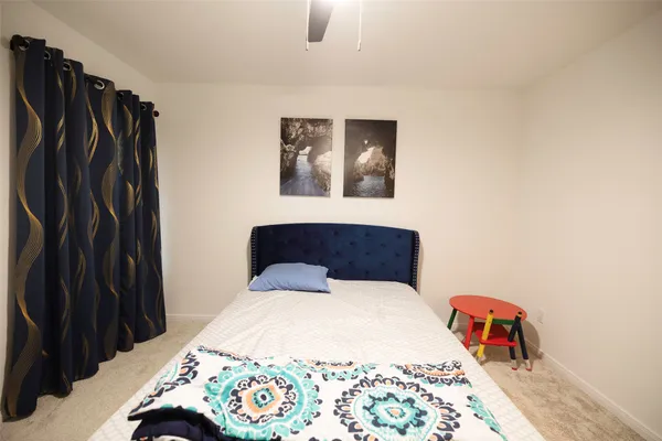 a bedroom with a bed and a table