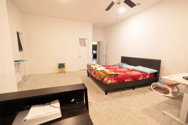 a bedroom with a bed and a chandelier