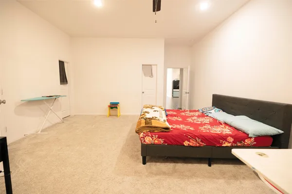 a bed sitting in a bedroom next to a bathroom