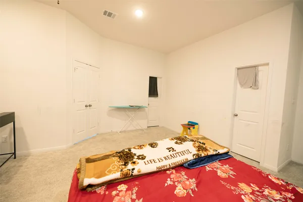 a bed room with a bed and a chair