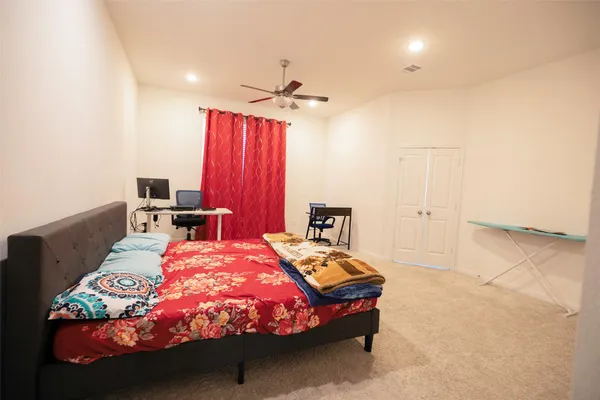 a bedroom with a bed and a chair