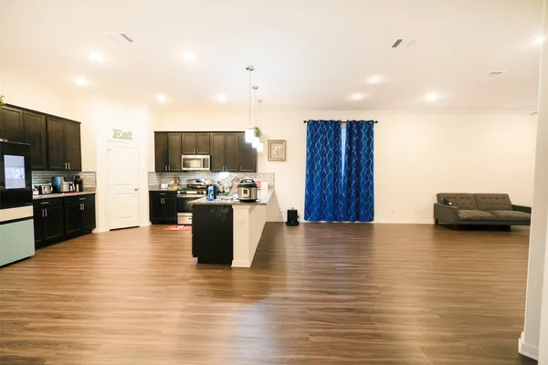a view of kitchen dining table kitchen appliances and a window