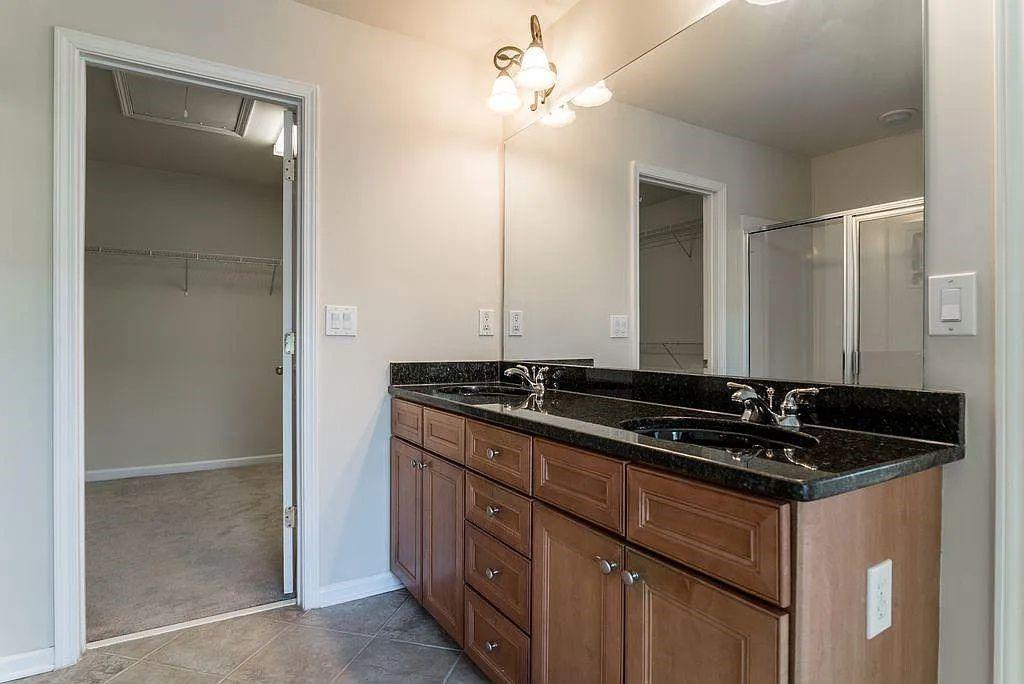 6120 Joybrook Road Duluth, GA 30097 - Photo 21 of 30 a bathroom with a sink and a mirror