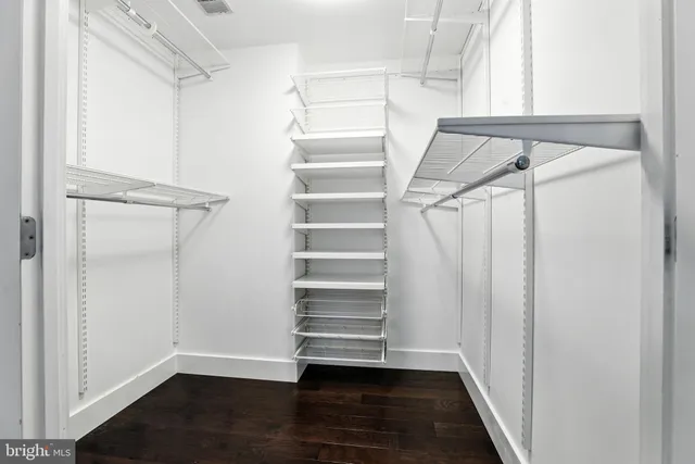a view of walk in closet with empty racks