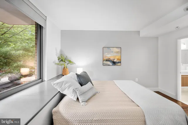 a bedroom with a bed and window