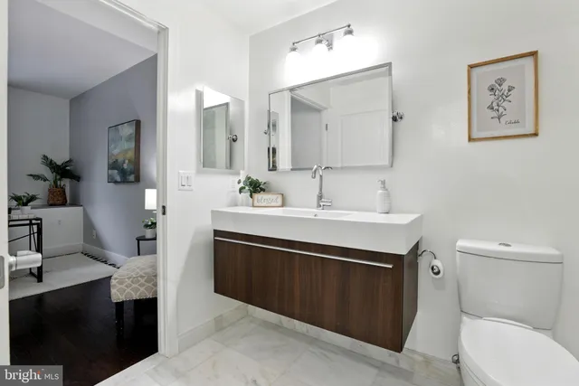 a bathroom with a sink vanity toilet and shower