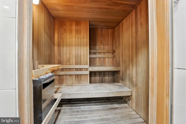 a kitchen with stainless steel appliances kitchen island granite countertop a table chairs and a refrigerator