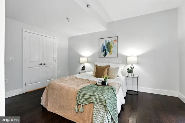 a bedroom with a bed and wooden floor