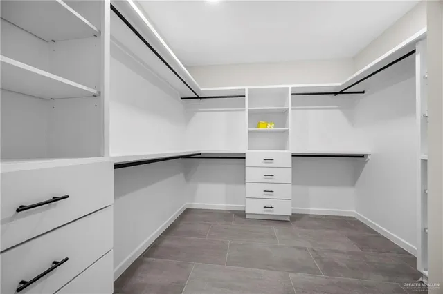 an empty room with a ceiling fan and window