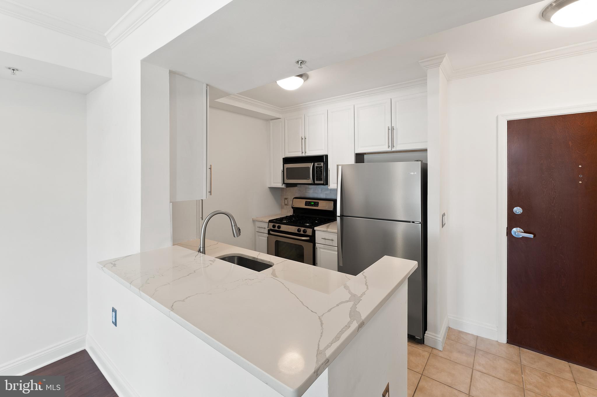 11760 Sunrise Valley Drive, Unit 809 Reston, VA 20191 - Photo 7 of 15 a kitchen with stainless steel appliances a refrigerator and a stove