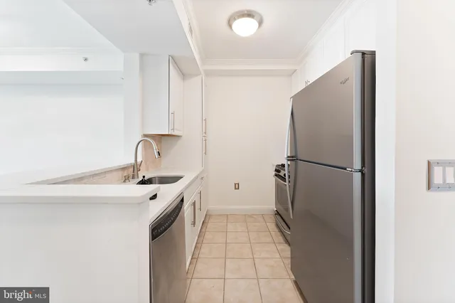a kitchen with a sink and refrigerator