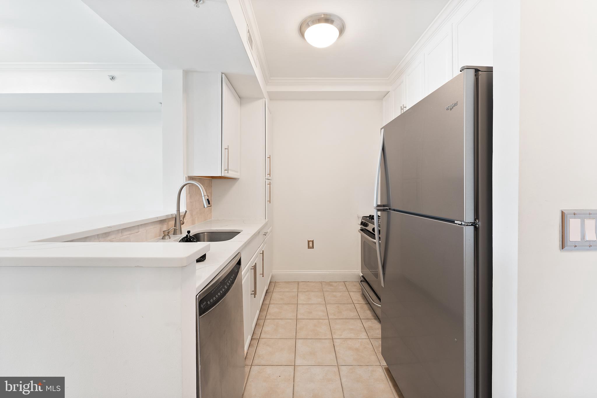 11760 Sunrise Valley Drive, Unit 809 Reston, VA 20191 - Photo 10 of 15 a kitchen with a sink and refrigerator