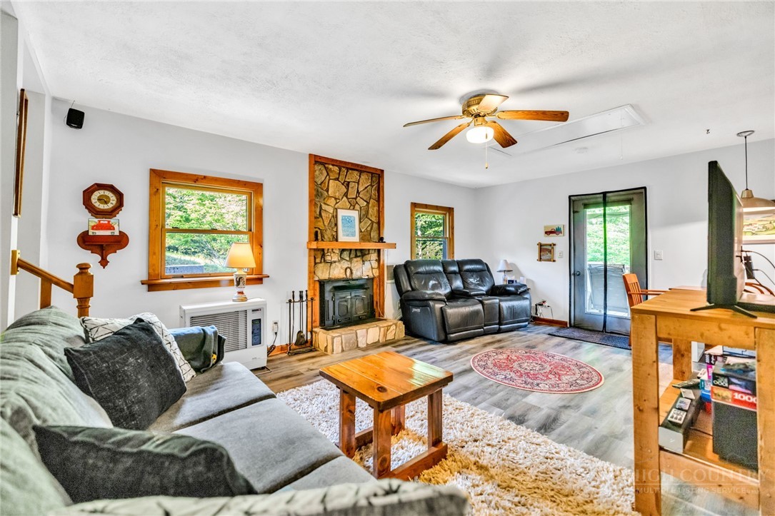 242 Ladd Parson Road Crumpler, NC 28617 - Photo 11 of 36 a living room with furniture a flat screen tv and a window