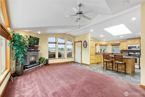 a view of a livingroom with furniture and a kitchen