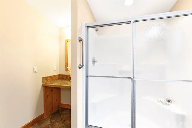 a bathroom with a shower and a sink